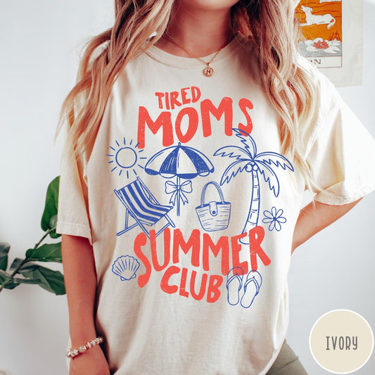 Comfort Colors tee in Ivory featuring beach vacation style graphic with sun, umbrella, palm tree, and bag