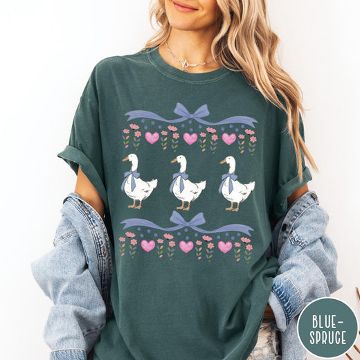 Comfort Colors tee in Blue Spruce featuring vintage style graphic with three geese wearing blue bows and hearts