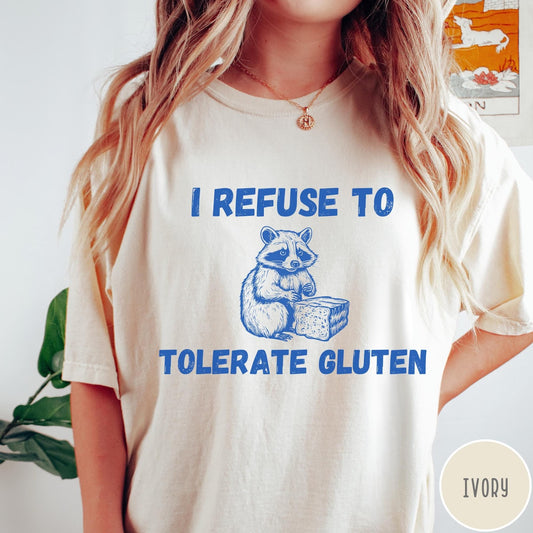 Comfort Colors tee in Ivory featuring graphic style illustration of a raccoon holding a loaf of bread