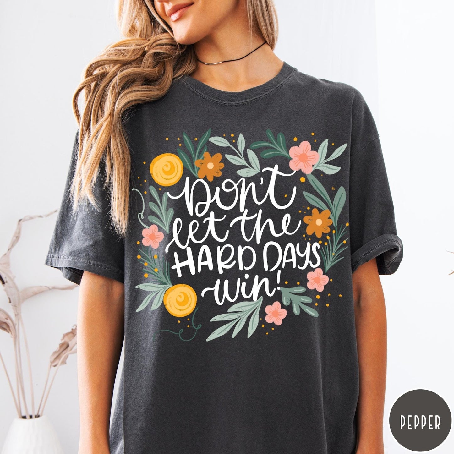 Comfort Colors tee in Pepper featuring floral mental health encouragement graphic with the text Don't Let The Hard Days Win