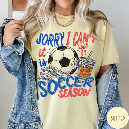 Comfort Colors tee in Butter featuring screen print style soccer season graphic with ball and iced coffee