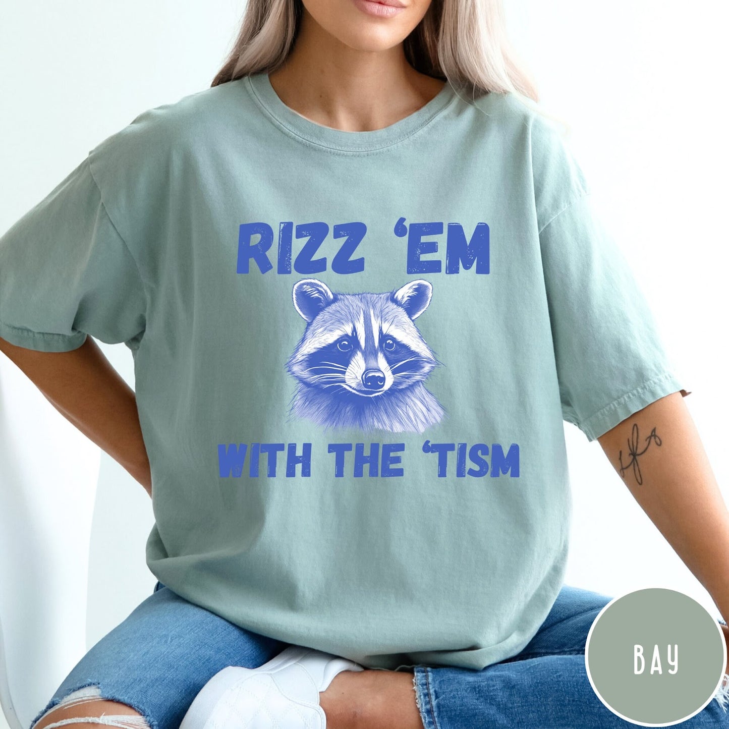Comfort Colors tee in Bay featuring screen printed raccoon graphic and Rizz Em With the Tism text
