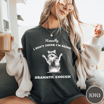 Comfort Colors tee in Pepper featuring vintage style graphic of a raccoon with arms raised and text