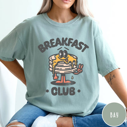 Comfort Colors tee in Bay featuring retro style graphic of a pancake character with syrup and peace sign