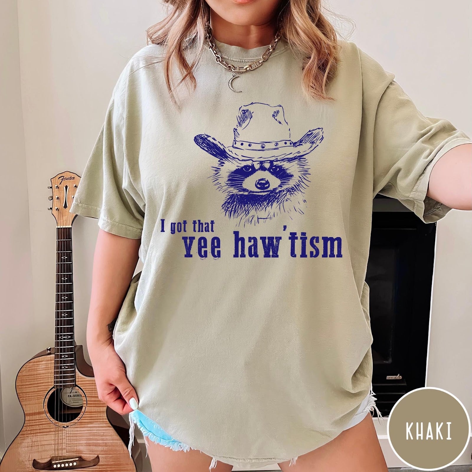 Comfort Colors tee in Khaki featuring western style graphic of a raccoon wearing a cowboy hat