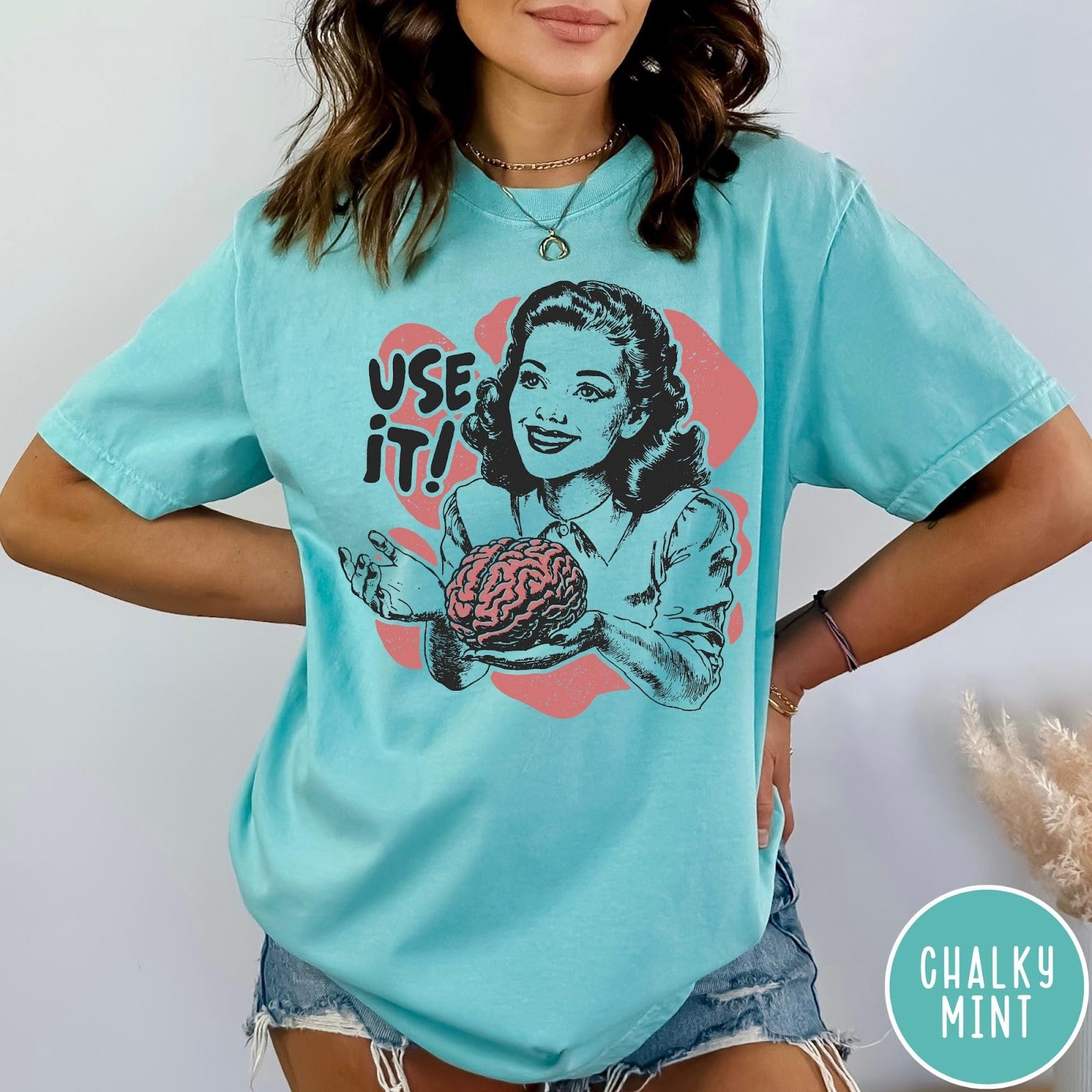 Comfort Colors tee in Chalky Mint featuring retro design of a woman holding a brain with text Use It
