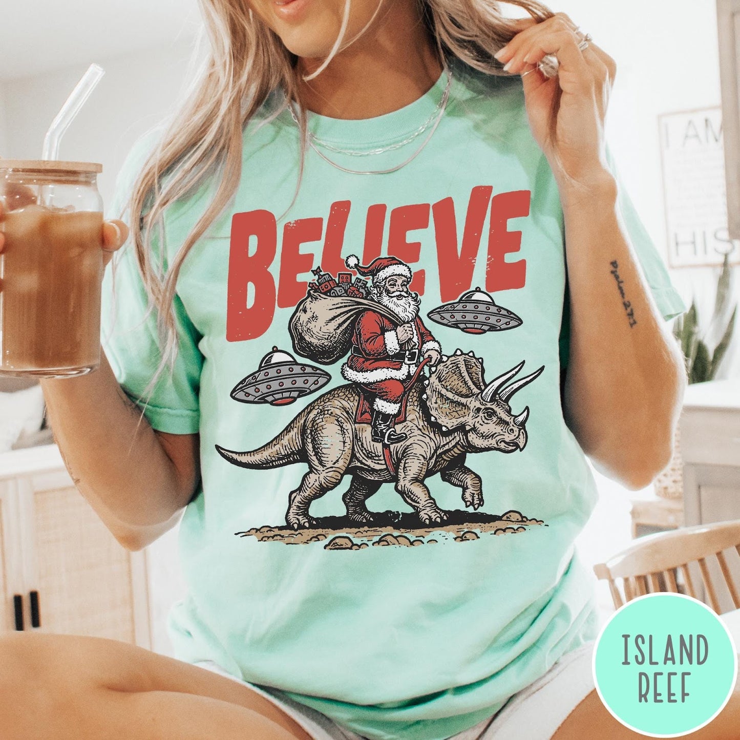 Comfort Colors tee in Island Reef featuring vintage style graphic of Santa riding a dinosaur with flying saucers