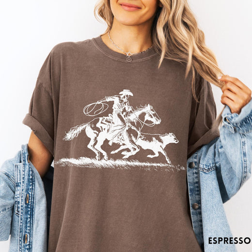 Comfort Colors tee in Espresso featuring western style graphic of a cowboy roping a calf on horseback