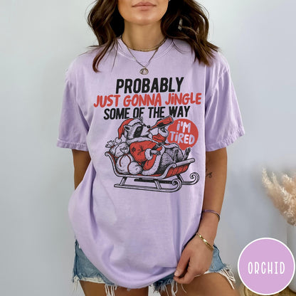 Comfort Colors tee in Orchid featuring vintage style graphic of a tired raccoon in a Santa sleigh