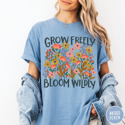 Comfort Colors tee in Washed Denim featuring wildflower design with text Grow Freely Bloom Wildly in earthy tones