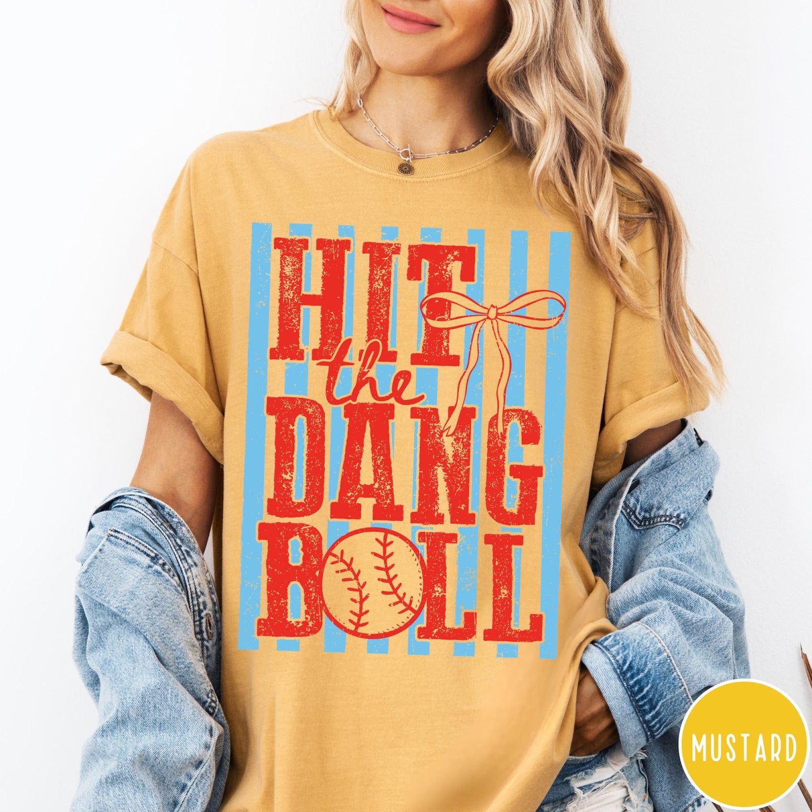 Comfort Colors tee in Mustard featuring baseball design with red text and a blue striped background graphic