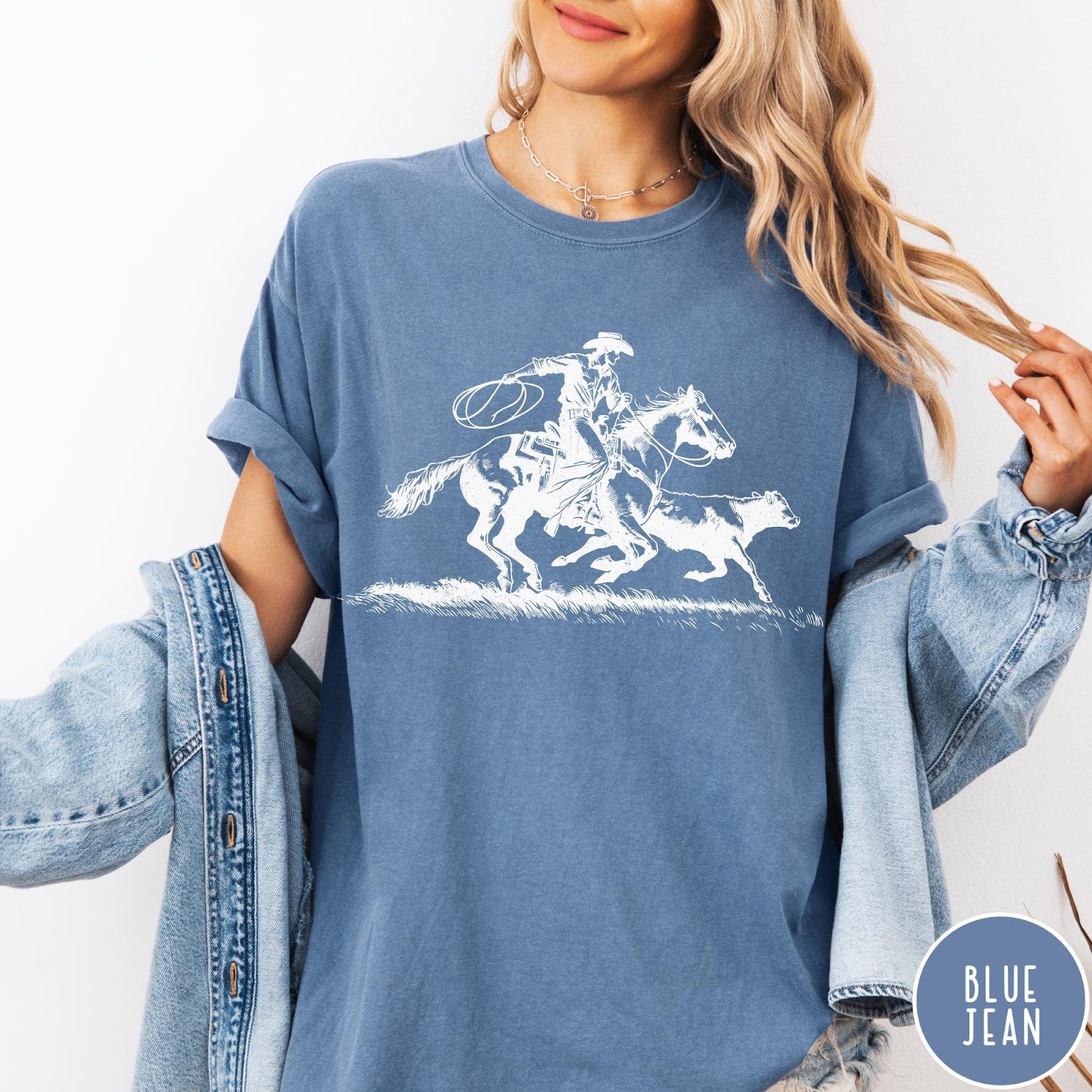 Comfort Colors tee in Blue Jean featuring western style graphic of a cowboy roping a calf on horseback