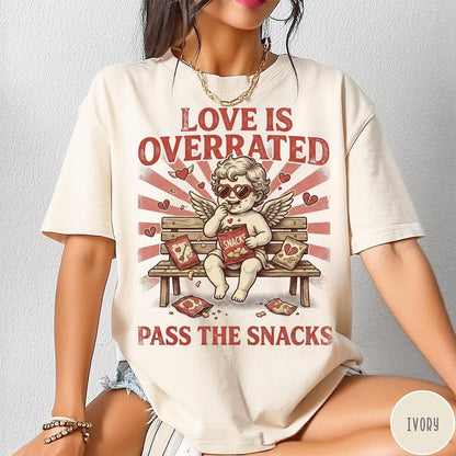 Comfort Colors tee in Ivory featuring vintage style graphic of a cherub eating snacks on a bench