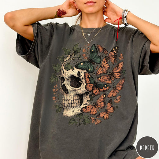 Comfort Colors tee in Pepper featuring vintage style graphic with a skull surrounded by various colorful butterflies