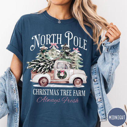 Comfort Colors tee in Midnight featuring vintage style Christmas tree farm truck graphic with snowy pine trees