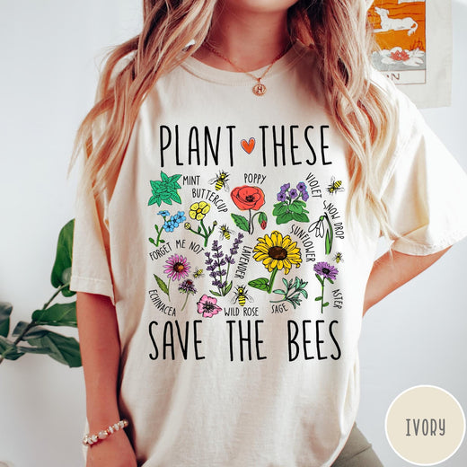Comfort Colors tee in Ivory featuring botanical garden style graphic with various flowers and bees
