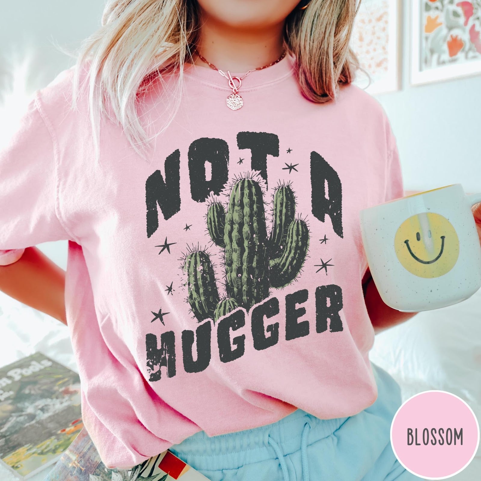 Comfort Colors tee in Blossom featuring cactus graphic and Not a Hugger text with small stars