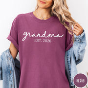Comfort Colors tee in Berry featuring cursive Grandma Est 2026 text in a clean white graphic style