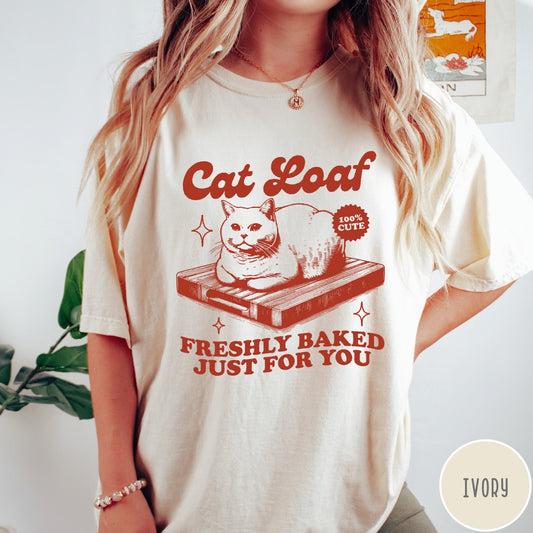 Comfort Colors tee in Ivory featuring graphic style cat loaf sitting on a wooden cutting board