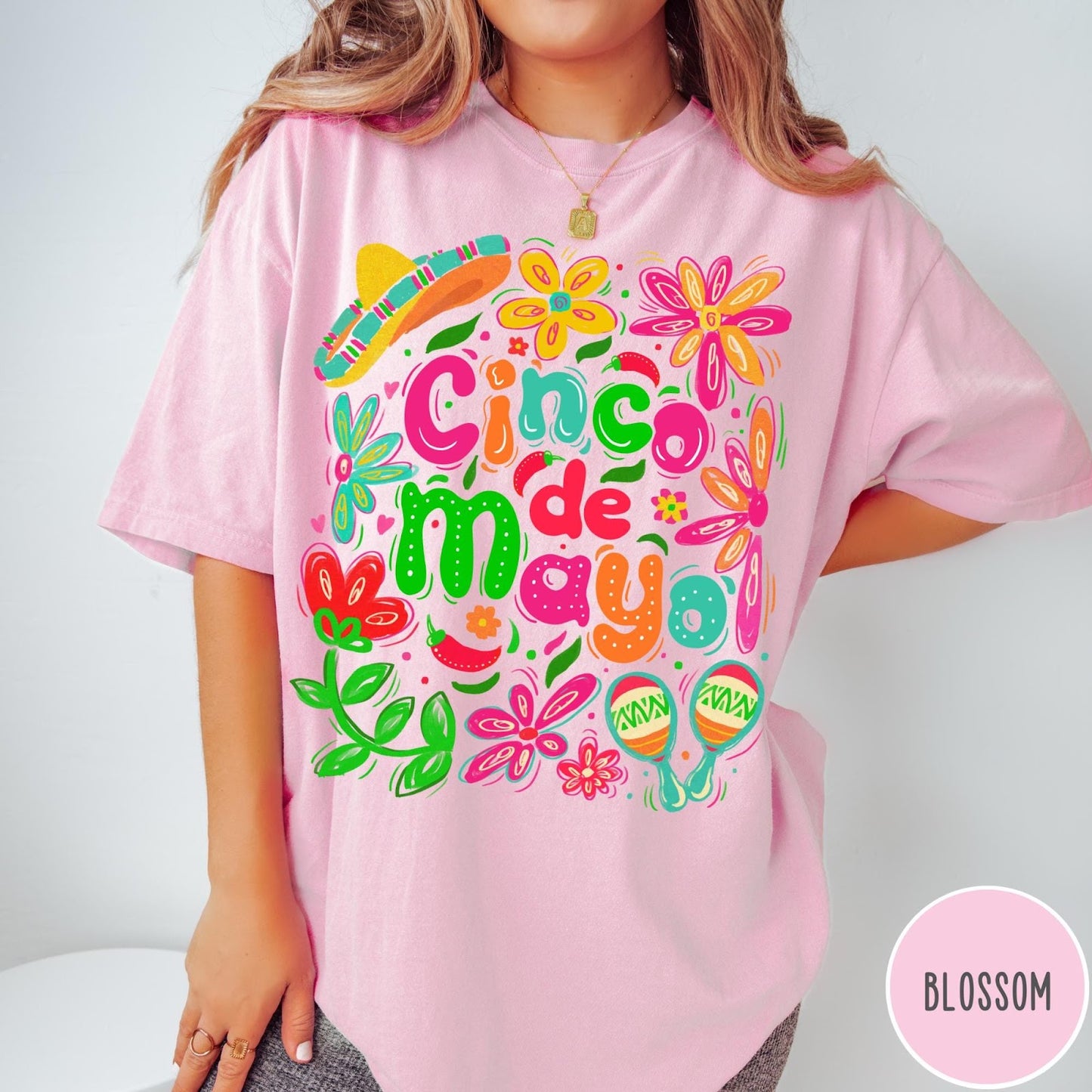Comfort Colors tee in Blossom featuring festive Cinco de Mayo graphic with flowers, sombrero, and maracas