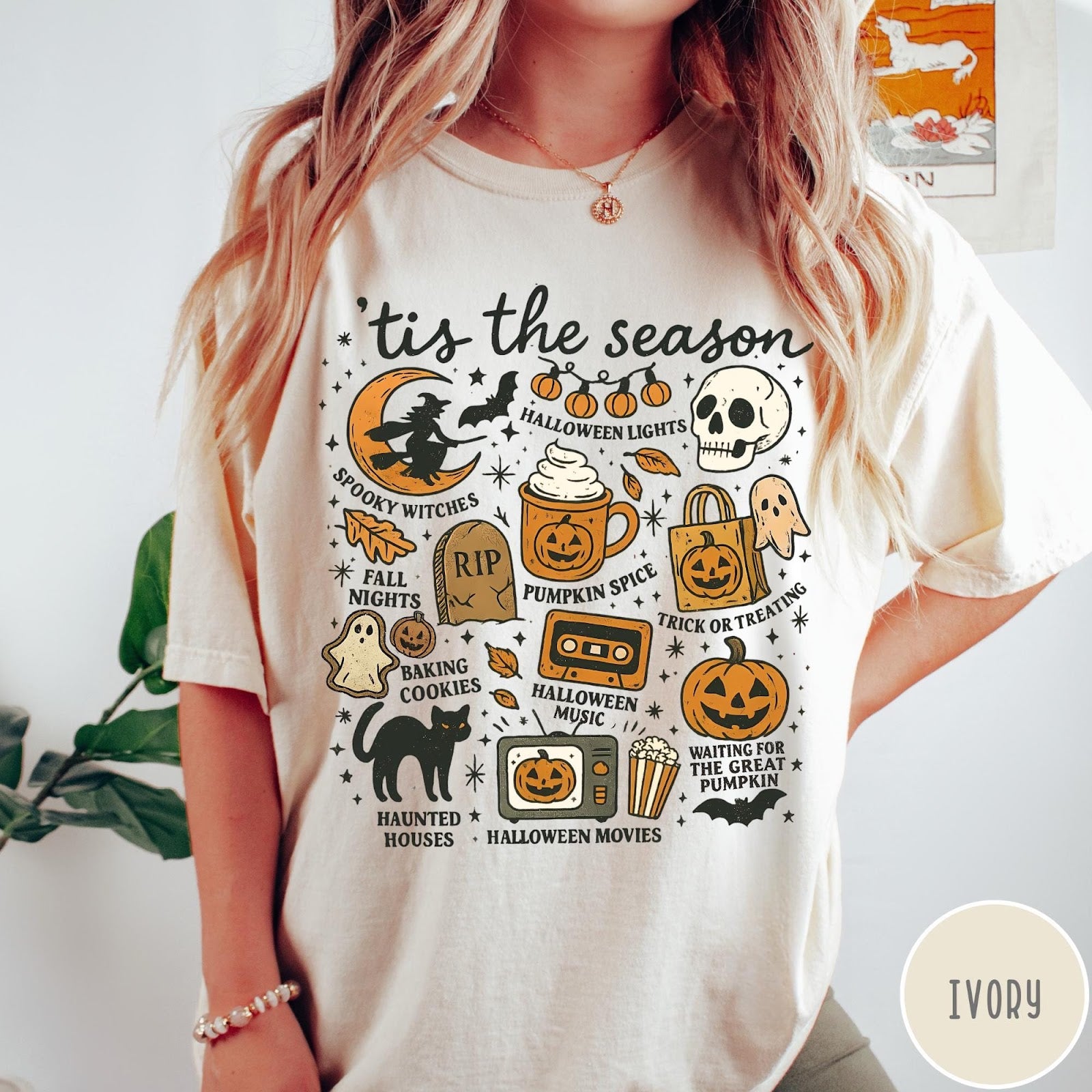 Comfort Colors tee in Ivory featuring Halloween icons collage with witch, skull, pumpkin, and spooky fall graphics