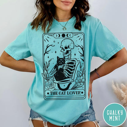 Comfort Colors tee in Chalky Mint featuring tarot style graphic of a skeleton holding a black cat