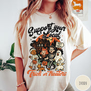 Comfort Colors tee in Ivory featuring vintage style trick or treaters graphic with a haunted house background