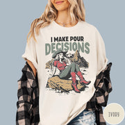 Comfort Colors tee in Ivory featuring western style graphic of a cowgirl sitting on a rock drinking