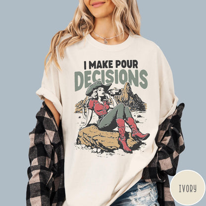 Comfort Colors tee in Ivory featuring western style graphic of a cowgirl sitting on a rock drinking