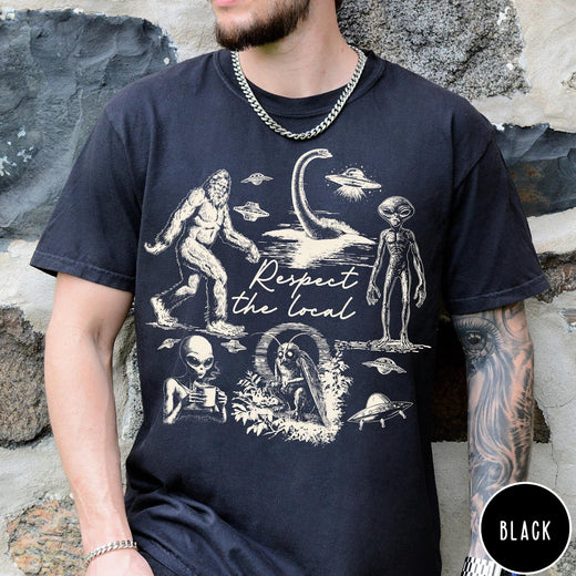 Comfort Colors tee in Black featuring vintage style graphic of Bigfoot, Loch Ness Monster, aliens, and UFOs