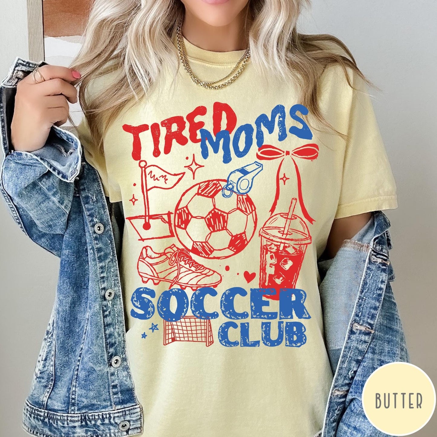 Comfort Colors tee in Butter featuring soccer mom life graphic with soccer ball, whistle, and iced coffee