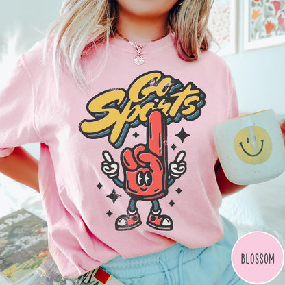 Comfort Colors tee in Blossom featuring retro mascot design with a red foam finger and Go Sports text