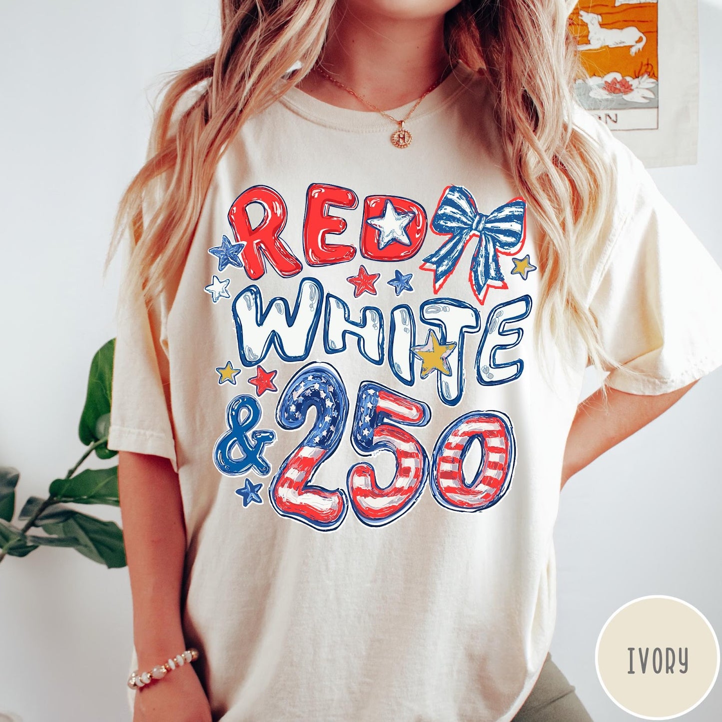 Comfort Colors tee in Ivory featuring patriotic 250th anniversary graphic with red white and blue stars and bow