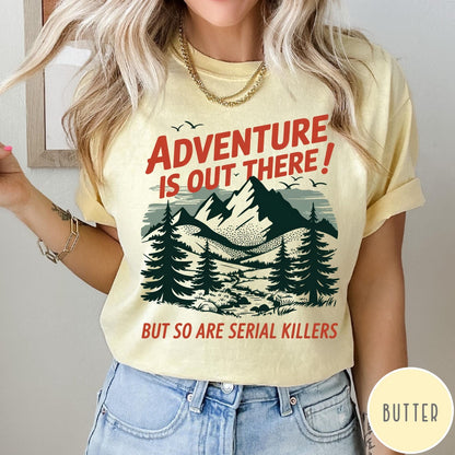 Comfort Colors tee in Butter featuring mountain and tree graphic with adventure and serial killer text design