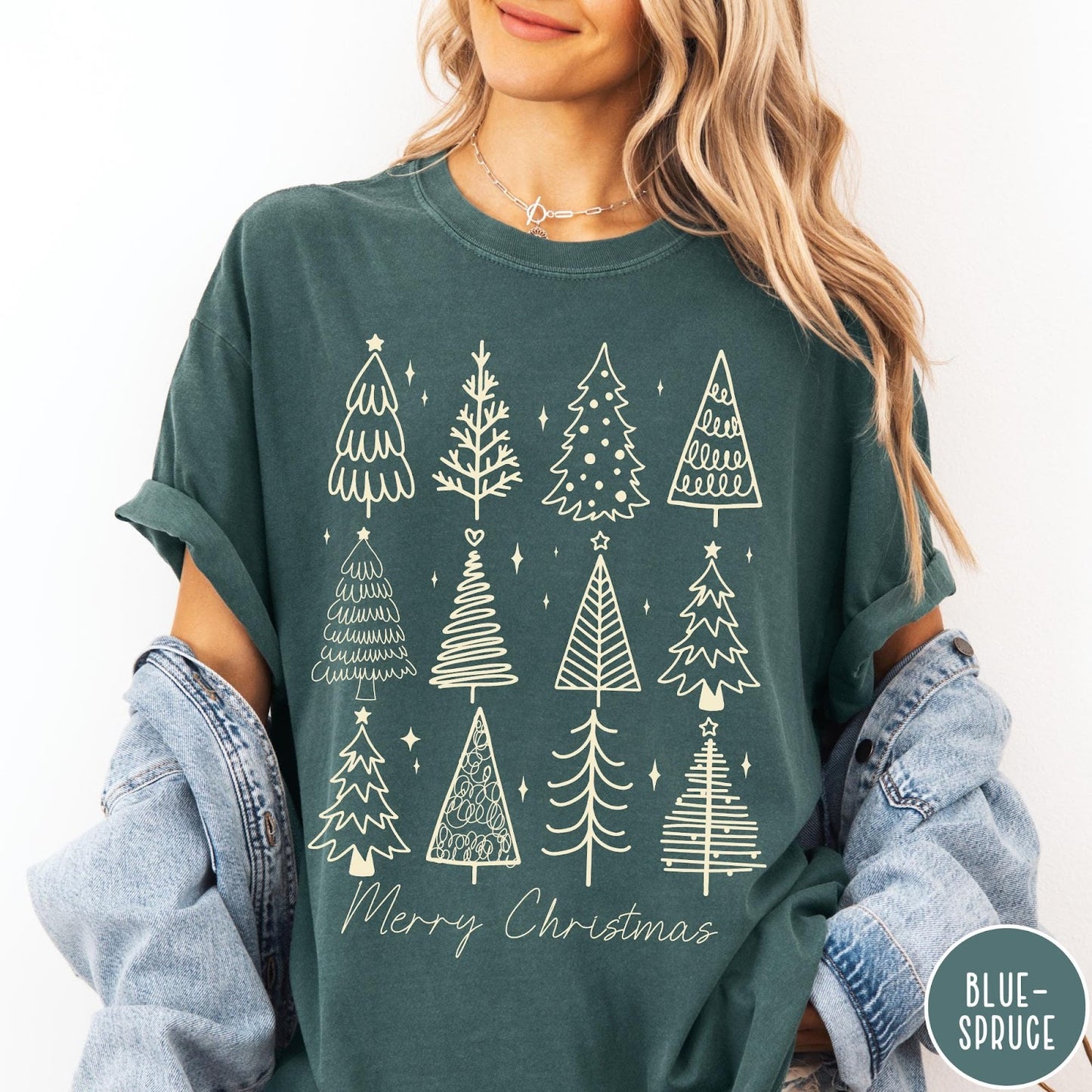 Comfort Colors tee in Blue Spruce featuring festive graphic style with twelve unique illustrated Christmas tree designs
