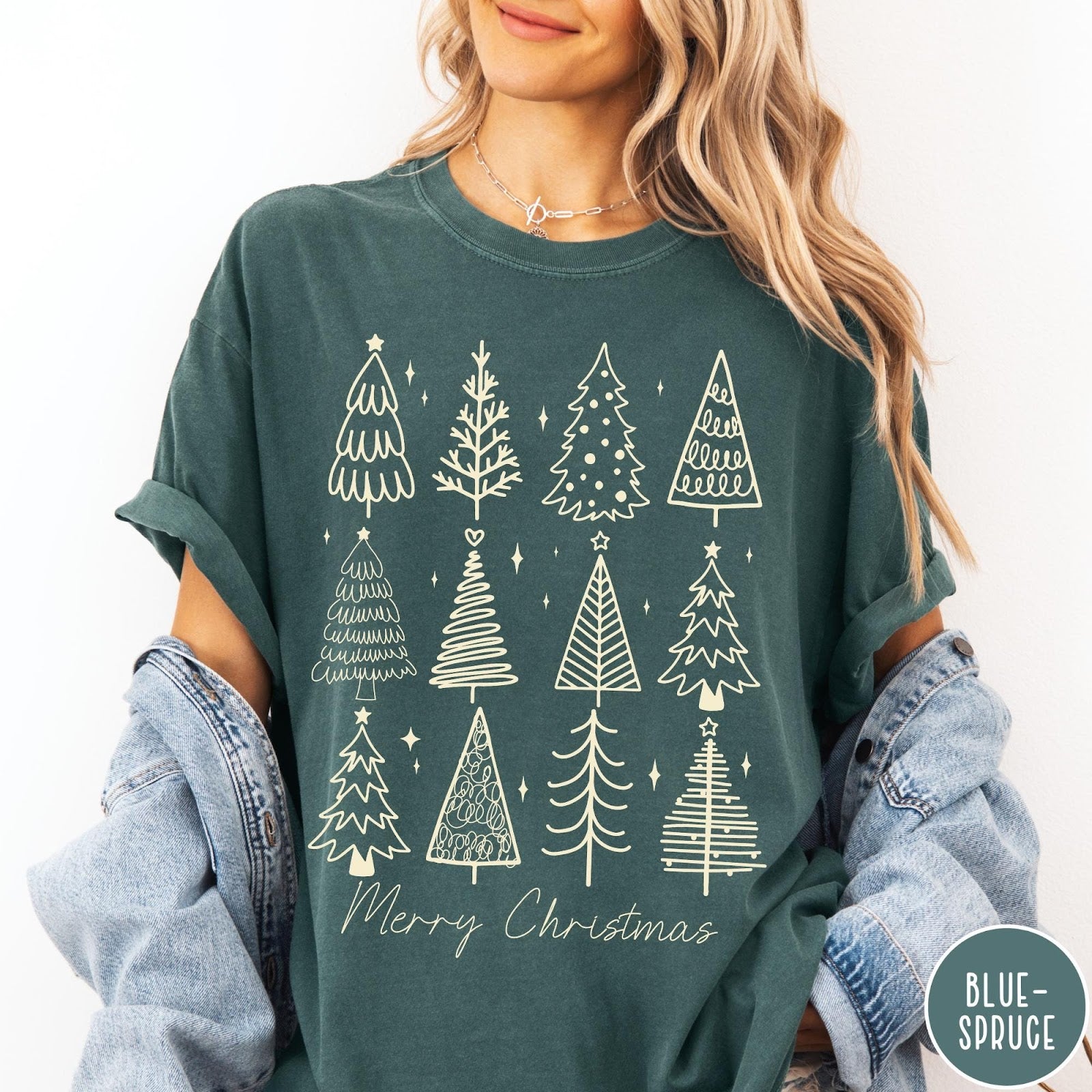Comfort Colors tee in Blue Spruce featuring festive graphic style with twelve unique illustrated Christmas tree designs
